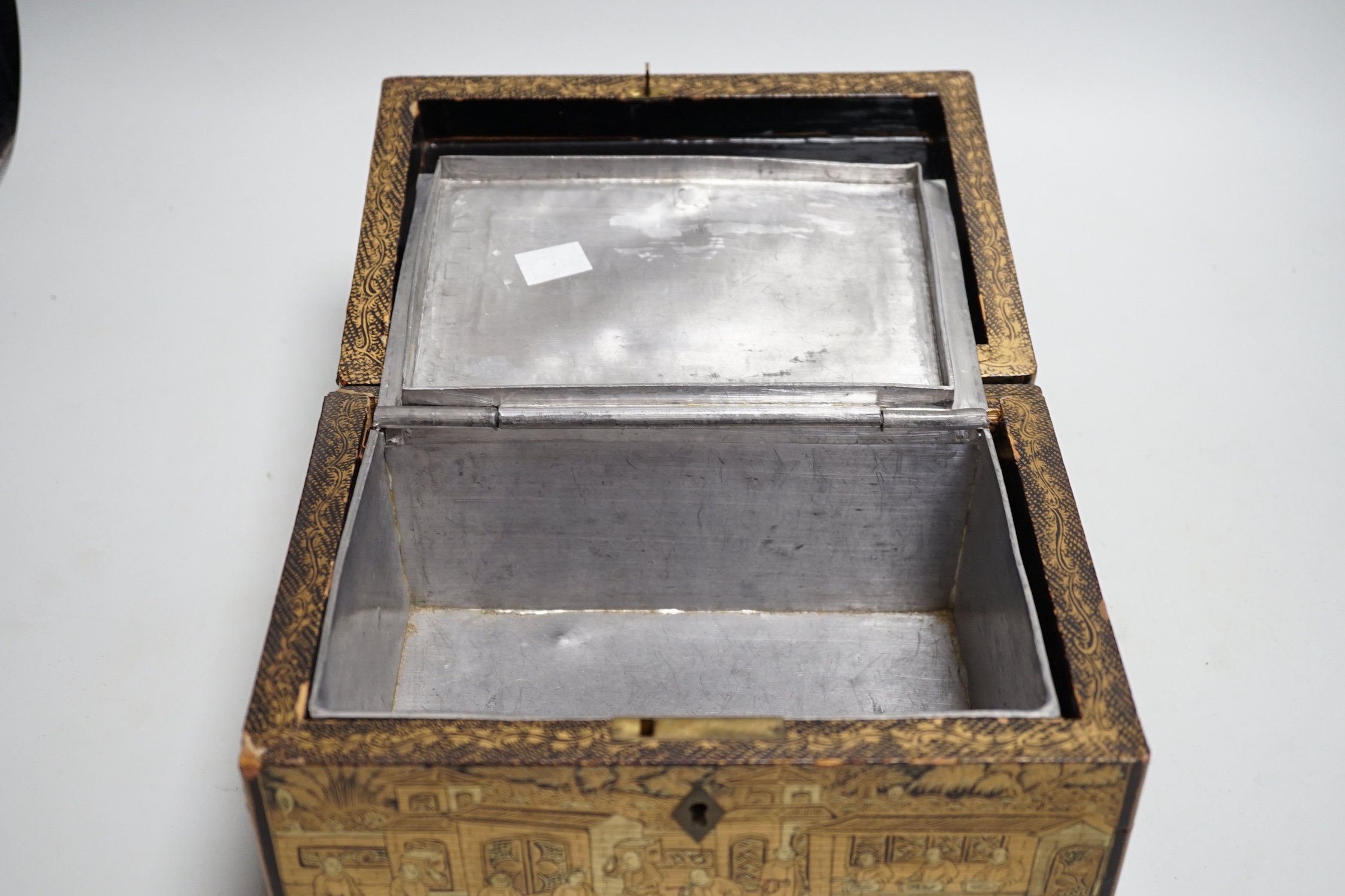 A 19th century Chinese export lacquer tea caddy, black ground with gilt decoration, containing a separate lidded pewter lining box with engraved decoration, 23cm x 16cm x 12cm